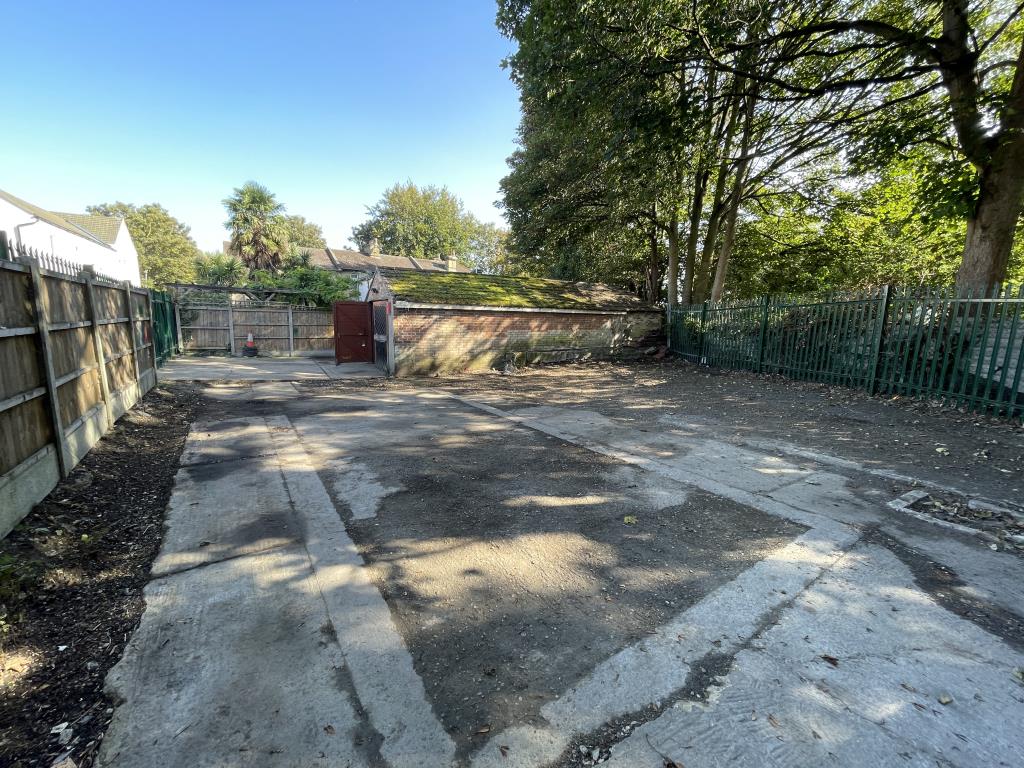 Lot: 53 - GATED STORAGE AND WORKSHOP YARD WITH POTENTIAL - View of garages from yard area